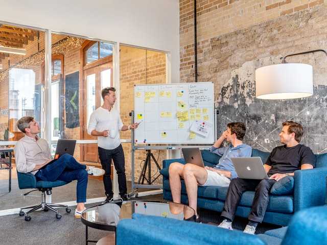 People in a meeting looking at a whiteboard